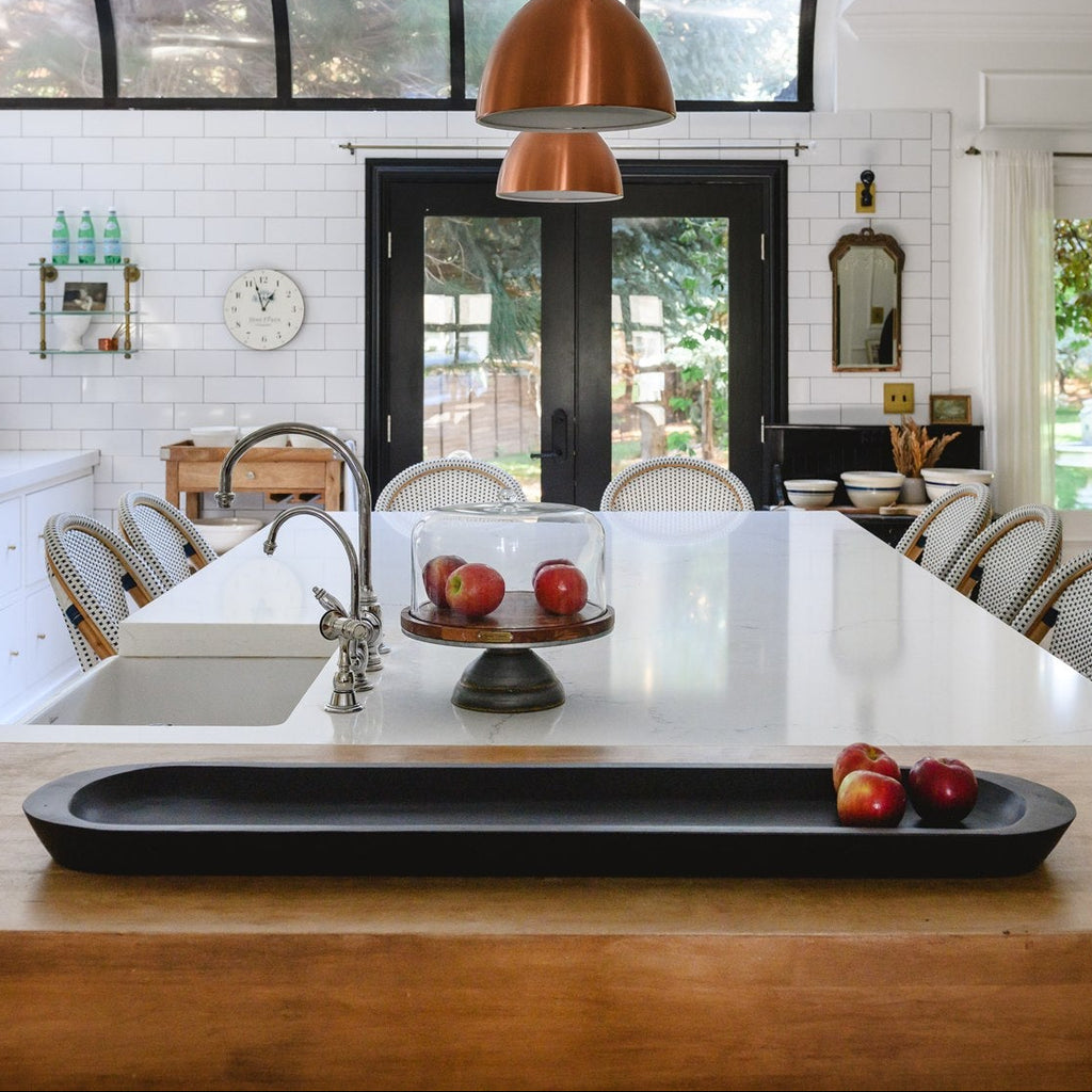Modern kitchen with wooden island, white countertops, and white cabinets.