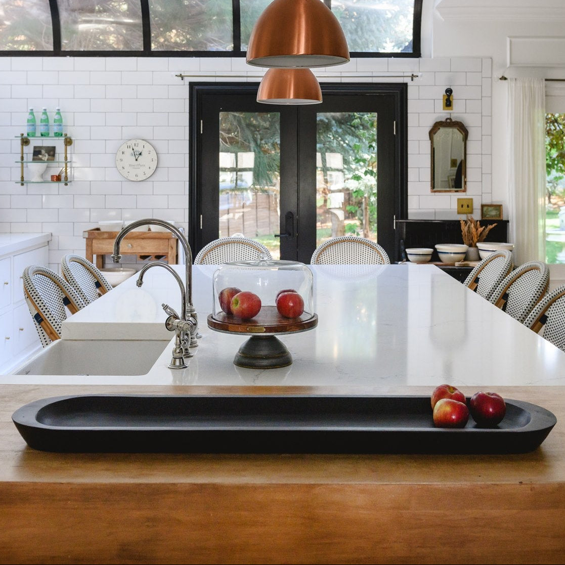 Modern kitchen with wooden island, white countertops, and white cabinets.